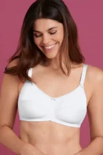 Žena gleda u pod, smeje se i nosi beli protezni grudnjak Allie 5301X spreda